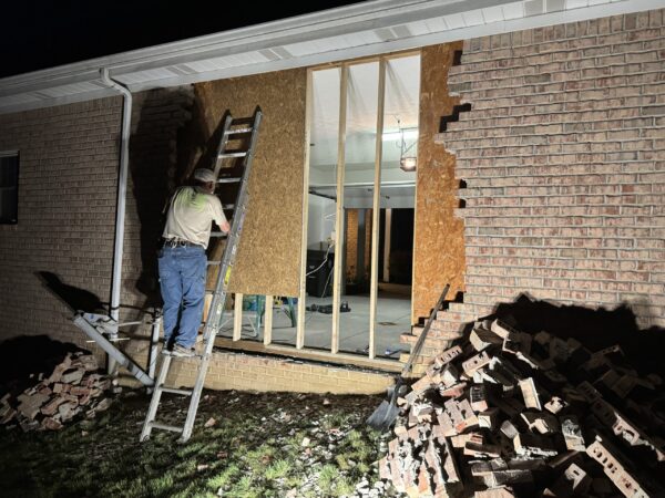 Emergency board up pic (1) An Extreme Restoration worker boards up a building after a storm.